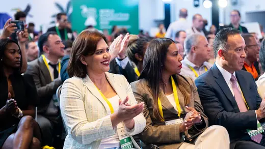 Delegates applauding in the front row of the opening ceremony