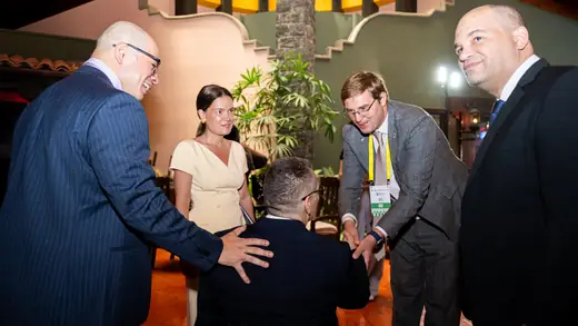 Delegates greeting each other after the opening ceremony
