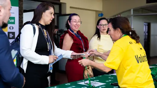 Volunteers handing out accreditation at the registration desk