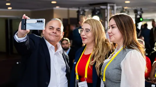 Participants photographing themselves together at the conference