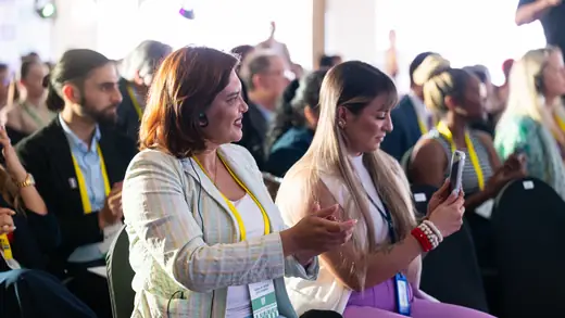 Audience applauding during a conference session