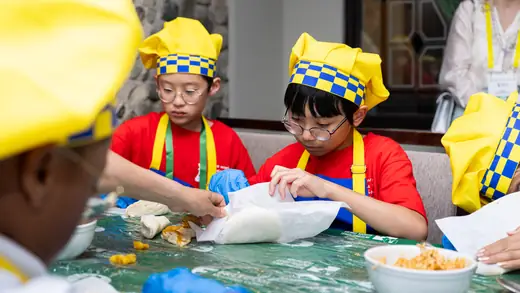 Young players making empanadas during the cooking master class