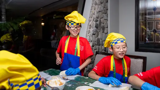 Young players making empanadas during the cooking master class