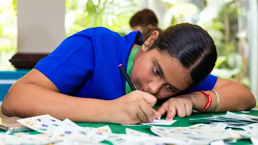 Children decorating their postcards with stickers and markers